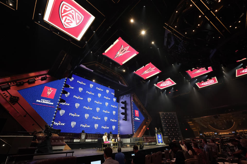 Arizona State head coach Kenny Dillingham, center, speaks at an NCAA college football Pac-12 media day Friday, July 21, 2023, in Las Vegas. (AP Photo/Lucas Peltier)