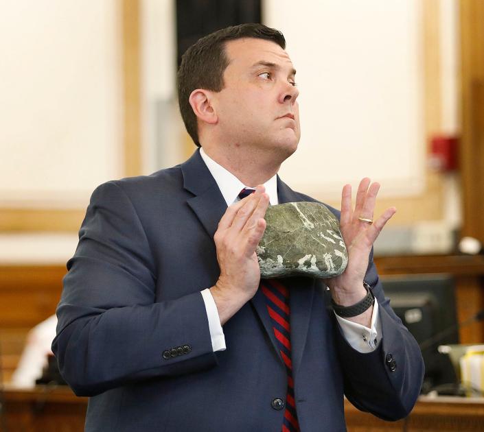 Prosecutor Greg Connor demonstrates how Lopes used a rock to knock Officer Chesna unconscious allowing him to take his gun and shoot him four times. Closing arguments in Norfolk Superior Court, Dedham in the double murder case against Emanuel Lopes who is charged with the death of Weymouth police officer Michael Chesna and Vera Adams.  Wednesday June 28, 2023 Greg Derr/ The Patriot Ledger/ Pool