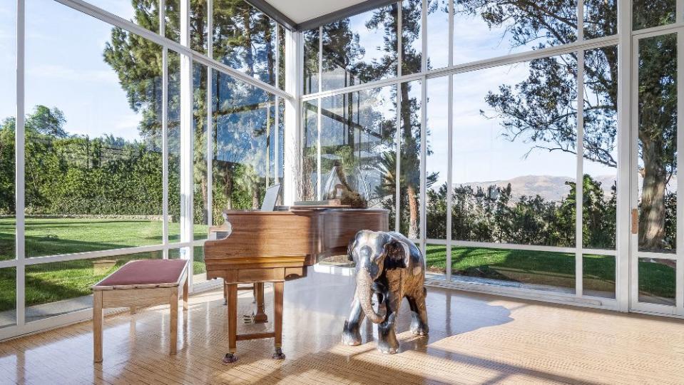 The former home of singer Frank Sinatra features a glass-walled piano room, of course.