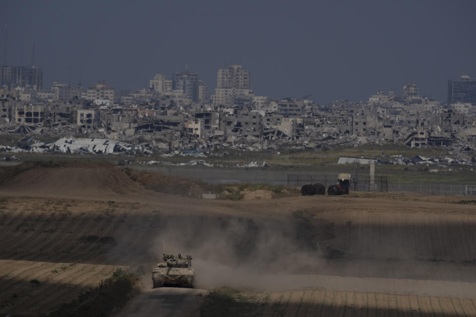 Israeli soldiers move on the top of a tank near the Israeli-Gaza border, as seen from southern Israel, Tuesday, April 9, 2024. (AP Photo/Leo Correa)