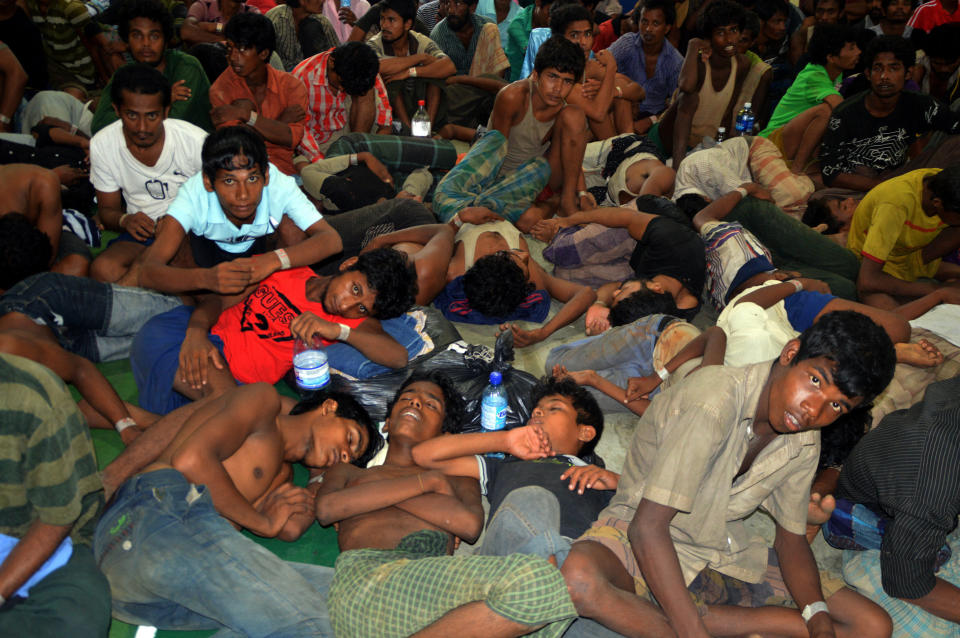 Migrants from Myanmar and Bangladesh arrive at the Langkawi police station's multi purpose hall in Langkawi, Malaysia on Monday, May 11, 2015. (AP Photo/Hamzah Osman)