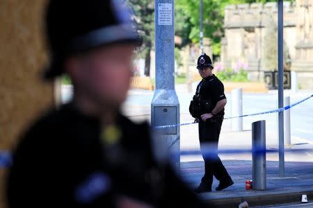 Police officers stand on duty at the cordon surrounding the Manchester Arena in Manchester, Britain, May 23, 2017. REUTERS/Jon Super