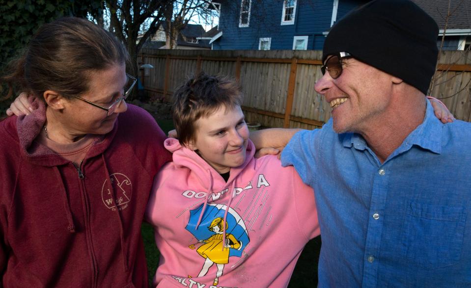 Becky Jones, left, with son Simen, 14, and husband Steve Connelly in the backyard of their home in Eugene, Oregon on Feb. 10, 2023. Connelly, a former school teacher, was diagnosed with stage 4 pancreatic cancer two years ago.