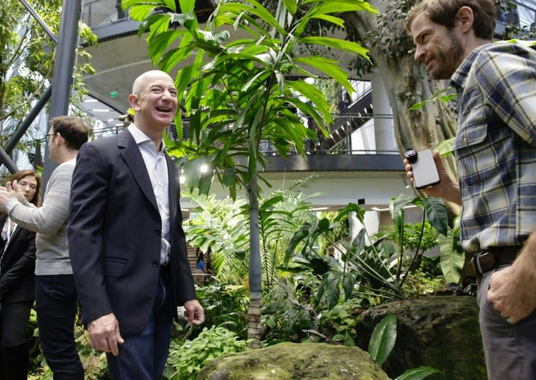 Amazon CEO Jeff Bezos tours the facility at the grand opening of the Amazon Spheres rainforest-inspired offices in Seattle, Washington on January 29, 2018