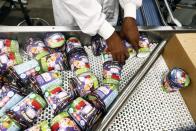 A worker handles tubs of Ben & Jerry's ice-cream at their factory in Be'er Tuvia, Israel