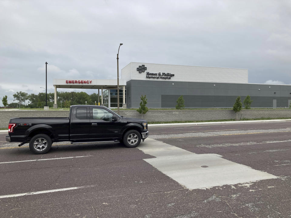 A truck passes by the new Homer G. Phillips Memorial Hospital in St. Louis, Mo., on Tuesday, Aug. 9, 2022. Some Black residents say use of the Homer G. Phillips name is cultural appropriation by a white developer. Homer G. Phillips Hospital served the Black community for decades before it closed in 1979. (AP Photo/Jim Salter)