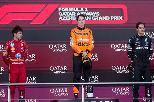 Oscar Piastri, centre, Charles Leclerc, left,  and George Russell on the podium