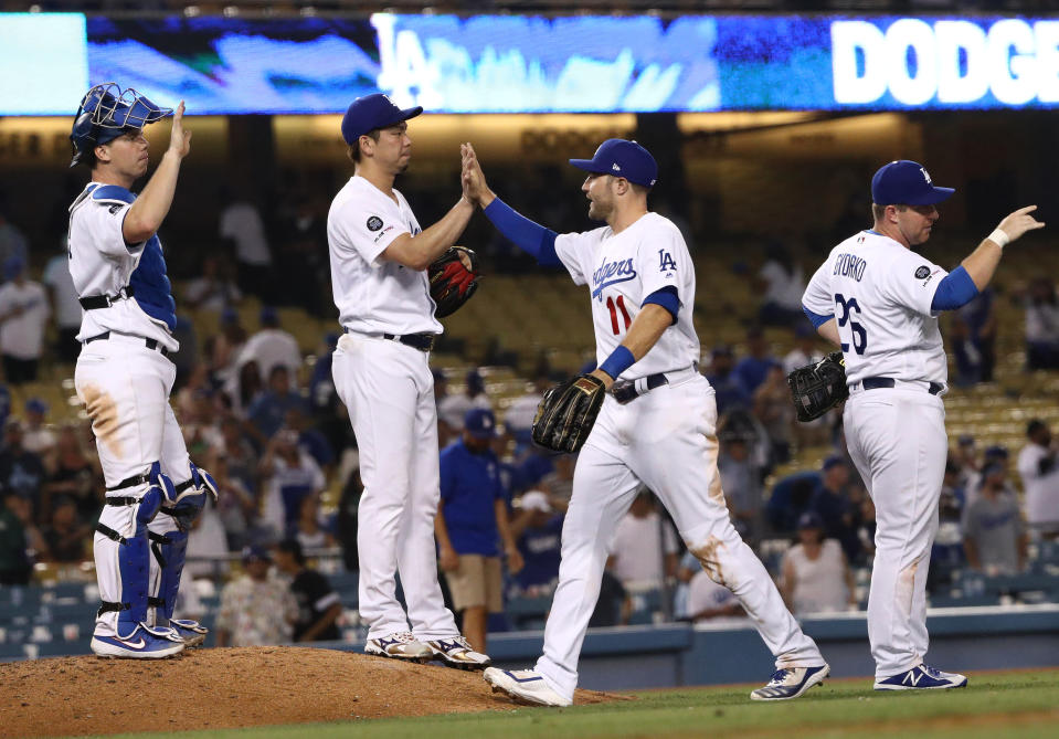 LOS ANGELES, CALIFORNIA - SEPTEMBER 02: (L-R) Catcher Will Smith #16, pitcher Kenta Maeda #18, A.J. Pollock #11 and Jedd Gyorko #26 of the Los Angeles Dodgers celebrate after the MLB game against the Colorado Rockies at Dodger Stadium on September 02, 2019 in Los Angeles, California. The Dodgers defeated the Rockies 16-9. (Photo by Victor Decolongon/Getty Images)