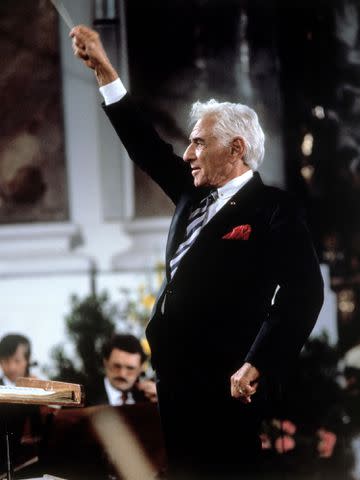 <p>kpa/United Archives/Getty</p> Leonard Bernstein conducting in 1988.