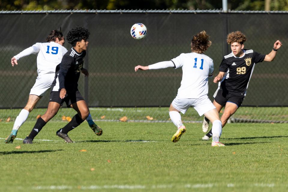 Penn's Daniel Contreras (22), Penn's Andre Gomez (99), and Lake Central's Miller Knestrict (11) look for the loose ball during the Lake Central -Penn high school 3A regional championship soccerl match on Saturday, October 15, 2022, at Penn High School in Mishawaka, Indiana.