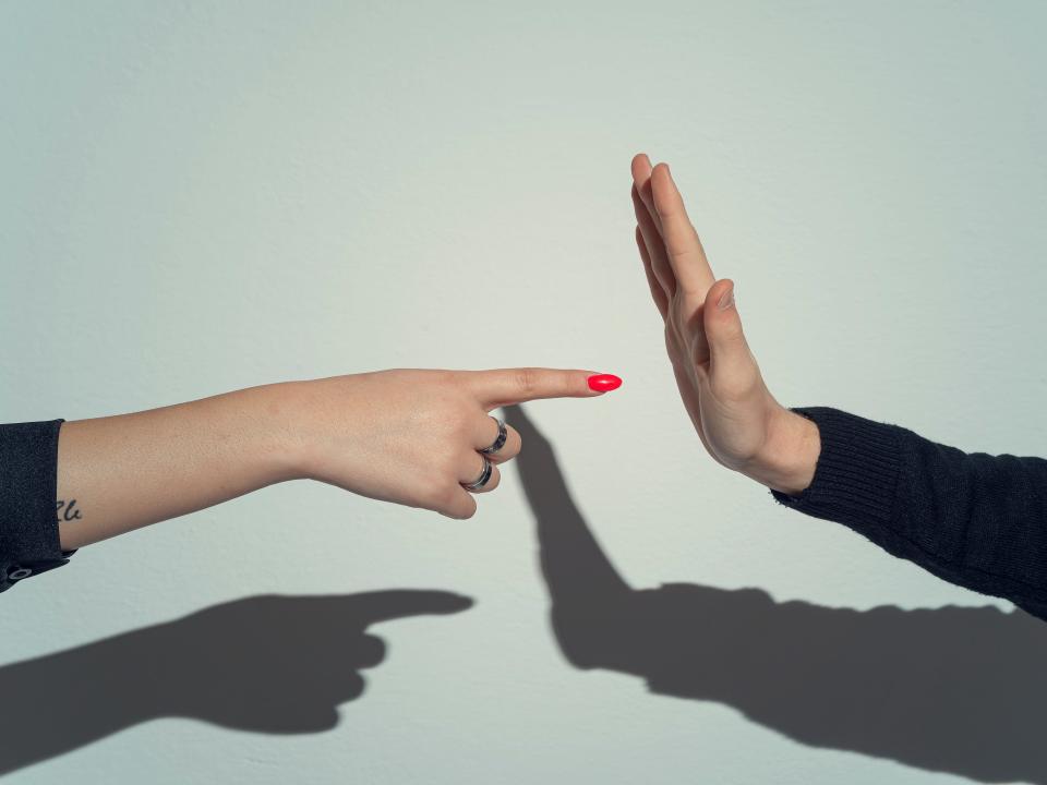 Two hands gesturing at an argument.