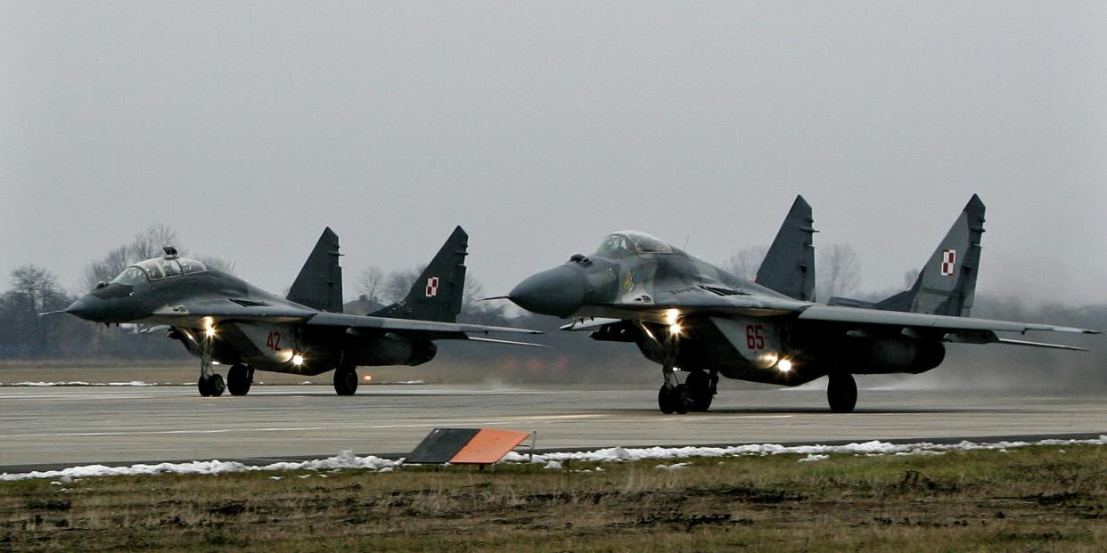 Polish MiG's-29 take off for a training mission at the military airport near Minsk Mazowiecki, east of Warsaw, December 6, 2005. As part of a rotational duty shared by members of the military alliance, Poland's MiGs will begin "air policing" missions over Estonia, Latvia and Lithuania in January. REUTERS/Peter Andrews