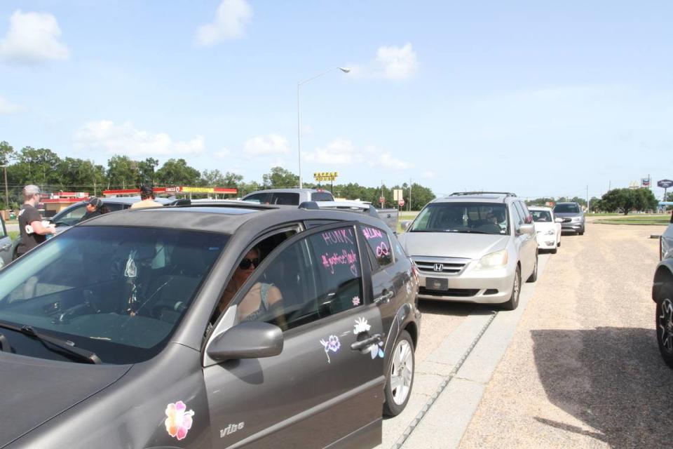 Vehicles line up Sunday so the drivers can have signs of support painted on their windows for the family of Aubreigh Wyatt, a 13-year-old Ocean Springs Middle School student who died by suicide and whose mother Heather Wyatt says she was bullied from fifth grade until her death as an eighth-grader.