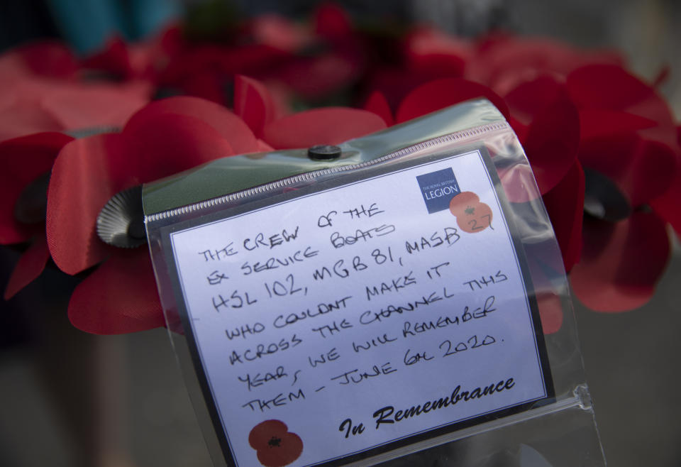 A poppy wreath with a message, for a group who could not attend D-Day remembrances, prior to being laid by British expatriate Steven Oldrid during D-Day ceremonies in Benouville, Normandy, France on Saturday, June 6, 2020. Due to coronavirus measures many relatives and veterans will not make this years 76th anniversary of D-Day. Oldrid will be bringing it to them virtually as he places wreaths and crosses for families and posts the moments on his facebook page. (AP Photo/Virginia Mayo)