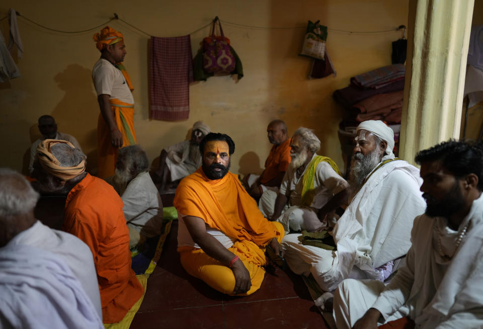 Hindu priest Swami Ram Das, 48, center, talks with elderly saints during a religious feast to celebrate Ramvami, the birthday of Hindu god Ram, in Ayodhya, India, March 29, 2023. Ram Das says India is on a quest to redeem its Hindu past and that the majority Hindus are finally getting their due. (AP Photo/Manish Swarup)