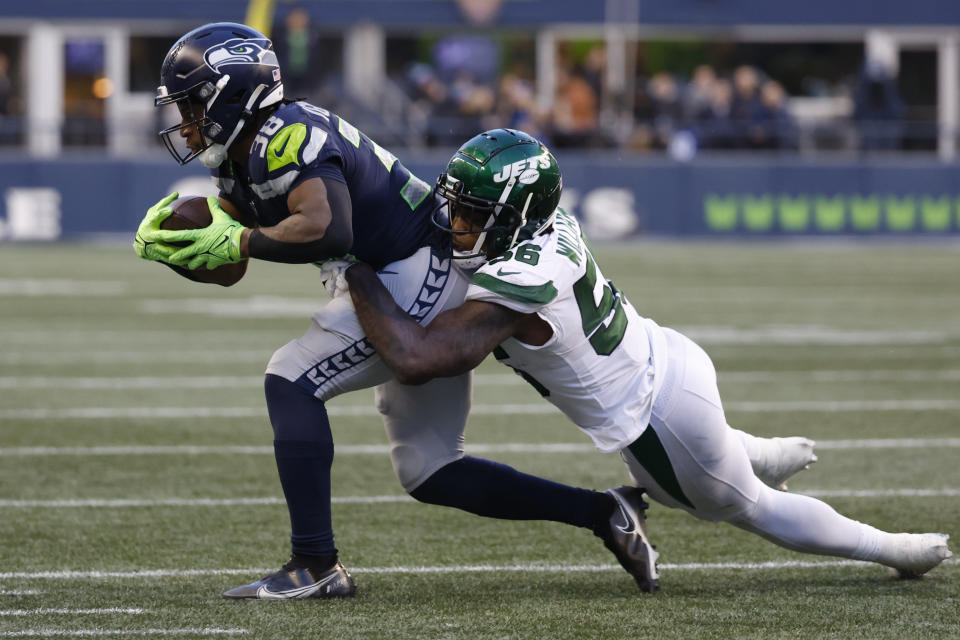 Jan 1, 2023; Seattle, Washington, USA; New York Jets linebacker Quincy Williams (56) tackles Seattle Seahawks running back Godwin Igwebuike (38) for a fourth down stop during the fourth quarter at Lumen Field. Mandatory Credit: Joe Nicholson-USA TODAY Sports