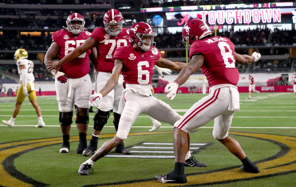 ARLINGTON, TEXAS - JANUARY 01: Wide receiver DeVonta Smith #6 of the Alabama Crimson Tide celebrates his touchdown with teammate wide receiver John Metchie III #8 in the first quarter of the 2021 College Football Playoff Semifinal Game at the Rose Bowl Game presented by Capital One against Notre Dame Fighting Irish at AT&T Stadium on January 01, 2021 in Arlington, Texas. (Photo by Tom Pennington/Getty Images)