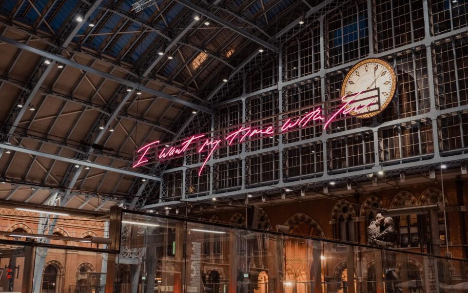 "I want my time with you" glowing pink words installation by Tracey Emin within interior of St. Pancras, one of the largest railway stations in London and home to Eurostar - Getty Images