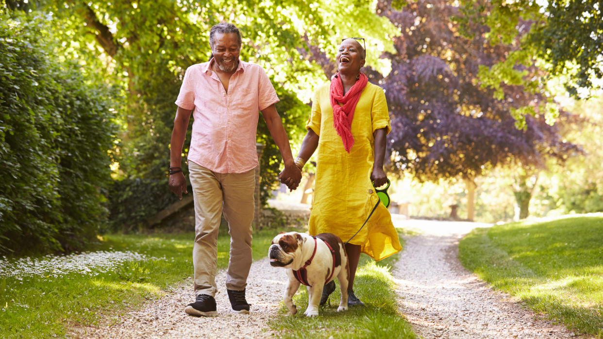 Senior Couple Walking With Dog