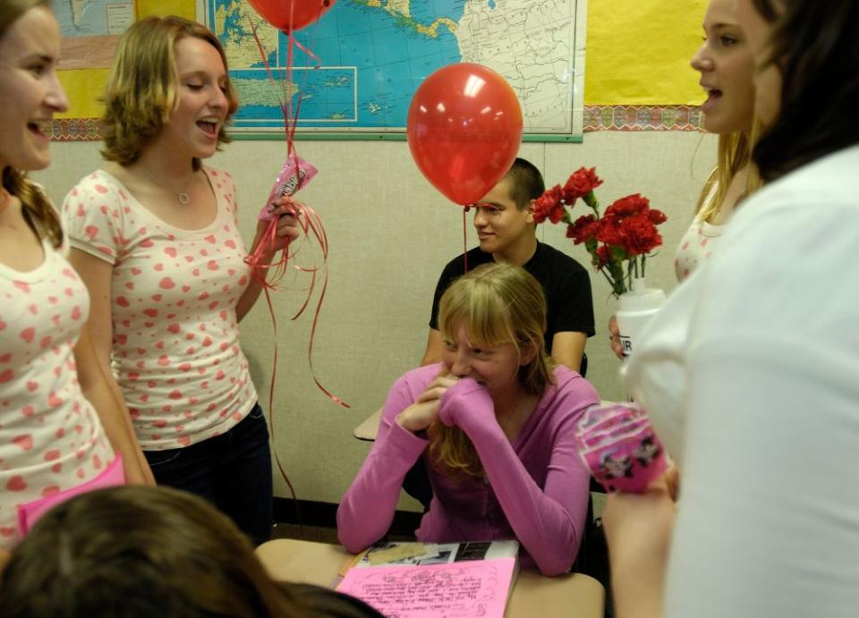 Holly Clarke, Mary Aarfet, Maegan Holman, Lori Nunnally, students in the Mayfair High School Vocal Program, head to a classroom to sing Valentine greeting to other students in Bellflower, California, on Feb. 14, 2007. The singers are raising money for a trip to Nashville, Tennessee. (Getty Images)