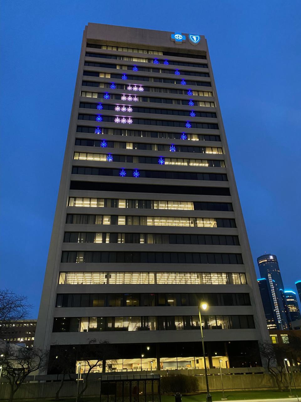 The Blue Cross Blue Shield of Michigan in Detroit is illuminated to celebrate the Lions' NFC North Division title.