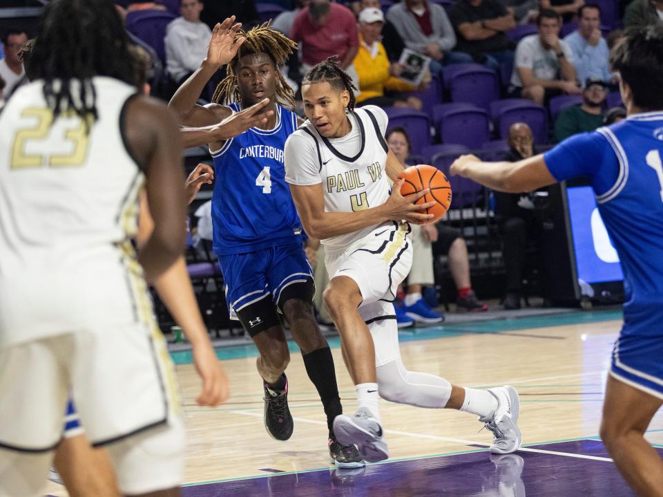 Isaiah Abraham of Paul VI drives around James Bryant of  Canterbury in the City of Palms Classic on Saturday, Dec. 17, 2022, at Suncoast Credit Union Arena in Fort Myers.