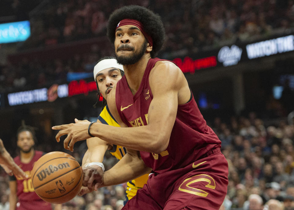 Cleveland Cavaliers' Jarrett Allen, right, is fouled by Indiana Pacers' Andrew Nembhard, center left, during the first half of an NBA basketball game in Cleveland, Friday, April 12, 2024. (AP Photo/Phil Long)