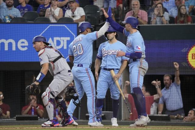 Texas Rangers' Ezequiel Duran, left, is caught stealing second