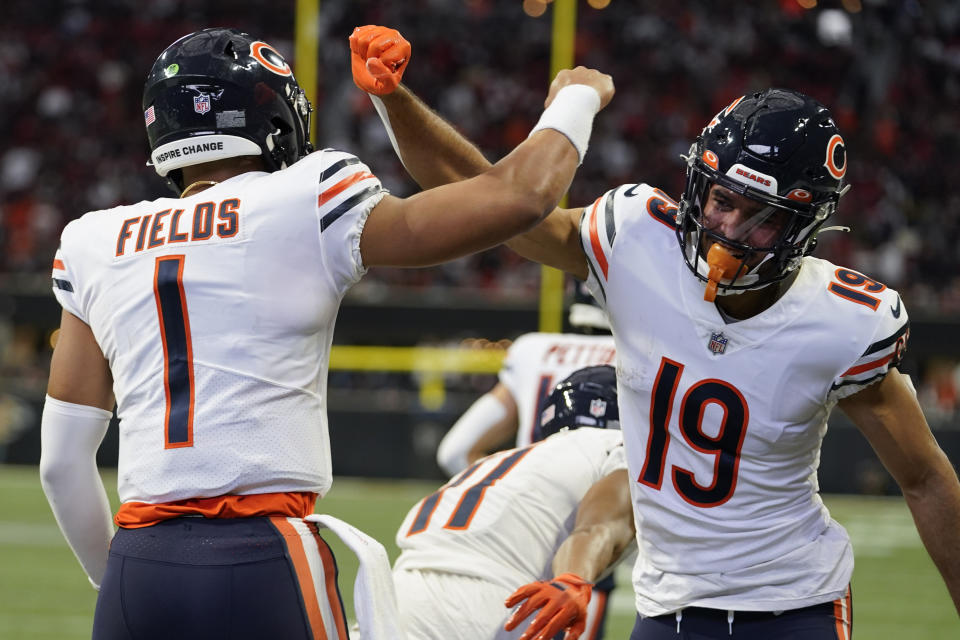 Chicago Bears quarterback Justin Fields (1) celebrates his touchdown with Chicago Bears wide receiver Equanimeous St. Brown (19) during the first half of an NFL football game against the Atlanta Falcons, Sunday, Nov. 20, 2022, in Atlanta. (AP Photo/Brynn Anderson)