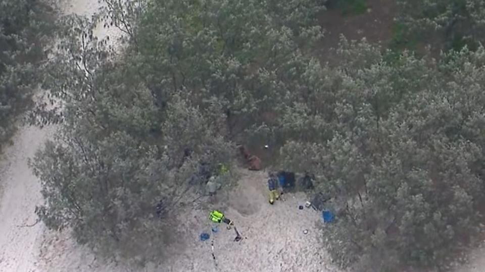 Queensland Paramedics and an RACQ Lifeflight rescue helicopter crew were called to help a 25-year-old man after he fell into a hole and was buried in sand on Bribie Island, north of Brisbane. Picture: NineNews