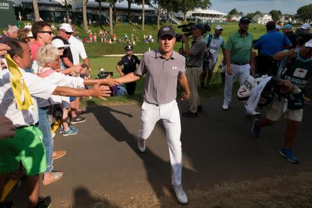 Jun 21, 2018; Cromwell, CT, USA; Jordan Spieth high fives fans as he walks off the 18th green during the first round of the Travelers Championship at TPC River Highlands. Mandatory Credit: Bill Streicher-USA TODAY Sports