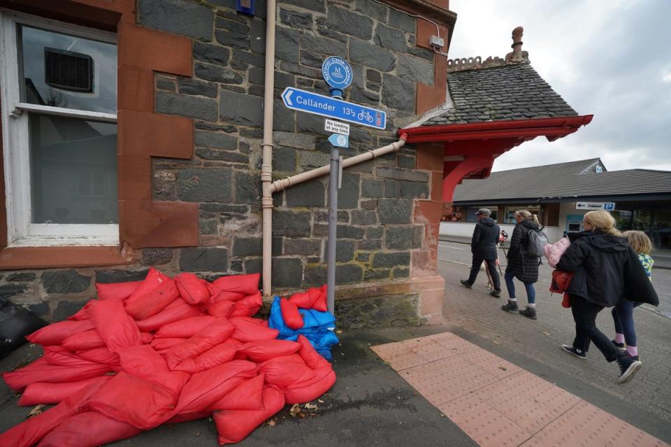Sand bags sit piled against a wall in Aberfoyle, Scotland, as residents prepare for the storm (PA)