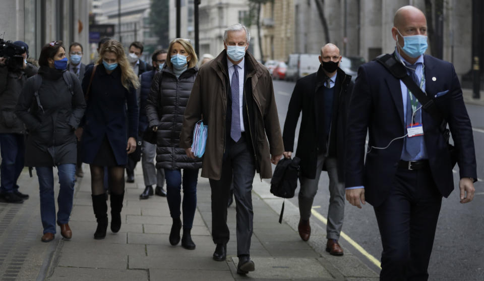 EU Chief Negotiator Michel Barnier, centre, with his team as he walks to a conference centre in Westminster in London, Sunday, Nov. 29, 2020. Teams from Britain and the European Union are continuing face-to-face talks on a post-Brexit trade deal in the little remaining time. (AP Photo/Kirsty Wigglesworth)