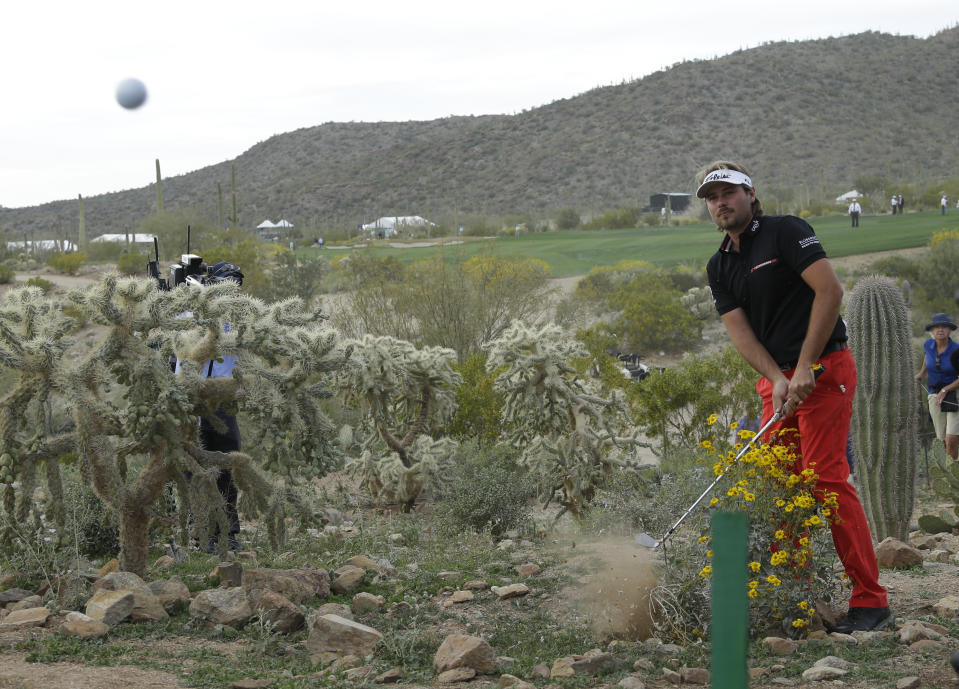 FILE - Victor Dubuisson, of France, hits out of the desert on the 20th hole in his championship match against Jason Day, of Australia, during the Match Play Championship golf tournament on Sunday, Feb. 23, 2014, in Marana, Ariz. The Match Play ends this year in Austin, Texas. His escape from the desert is among the most remarkable shots in tournament history. (AP Photo/Ted S. Warren, File)