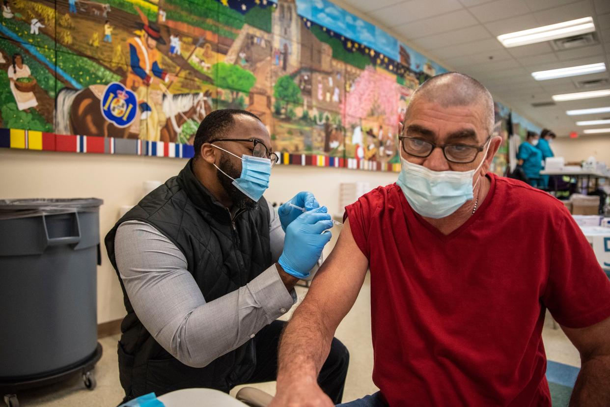 A patient receives his first dose of the Moderna COVID-19 vaccine at a vaccination site at a senior center on March 29, 2021, in San Antonio, Texas.