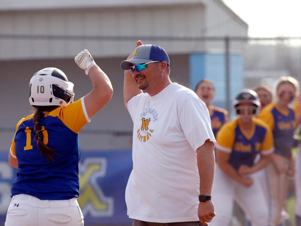 Lydiah Huey, left, is congratulated by West Muskingum coach Josh Bobo after hitting a go-ahead three-run homer in the fifth inning of a 15-9 loss to visiting Philo on Thursday in Falls Township. The loss snapped the Tornadoes' five-game winning streak.