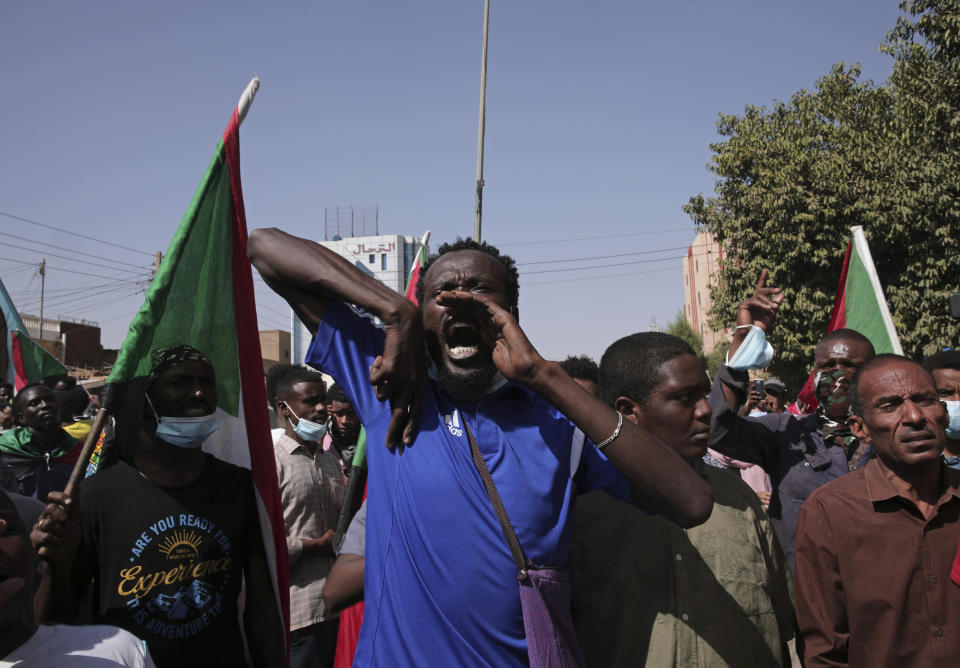 Tens of thousands of Sudanese calling for a civilian government march near the presidential palace in Khartoum, Sudan, Tuesday, Nov. 30, 2021. Security forces have fired tear gas at anti-coup protesters in the Sudanese capital on Tuesday, in the latest demonstrations against a military takeover that took place last month. (AP Photo/Marwan Ali)