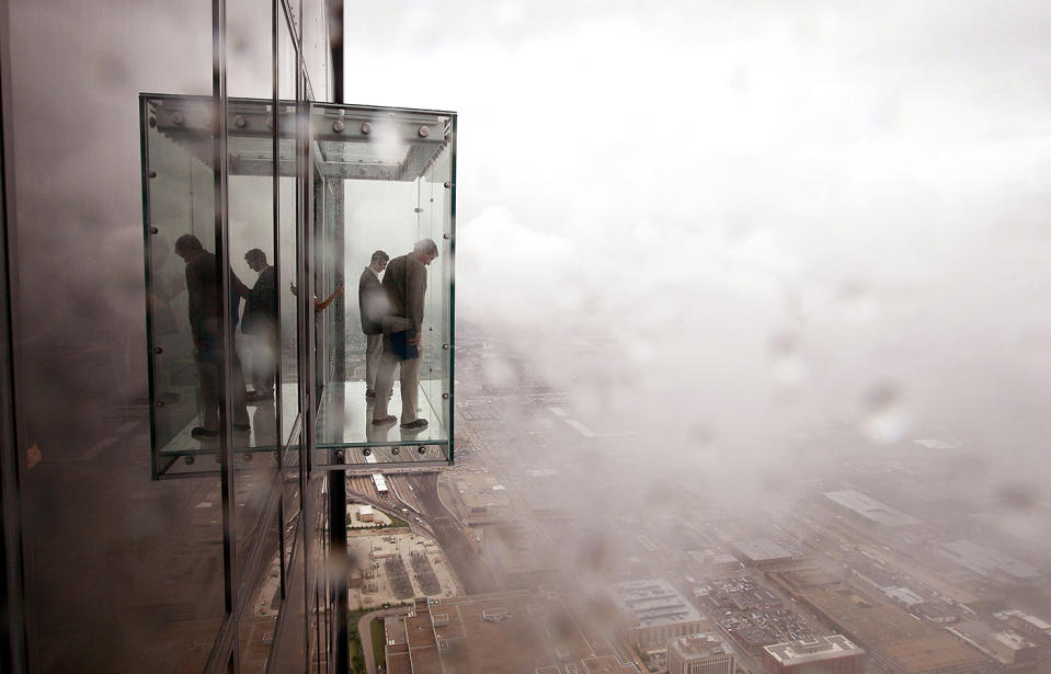 Visitors check out the view from the 103rd floor Skydeck of Chicago's Willis Tower SkyDeck glass cube, which has cracked.