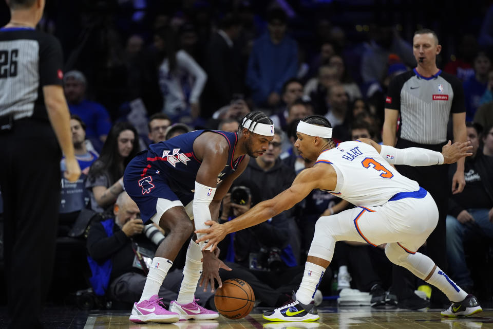 Philadelphia 76ers' Buddy Hield, left, tries to keep the ball away from New York Knicks' Josh Hart during the first half of an NBA basketball game, Thursday, Feb. 22, 2024, in Philadelphia. (AP Photo/Matt Slocum)