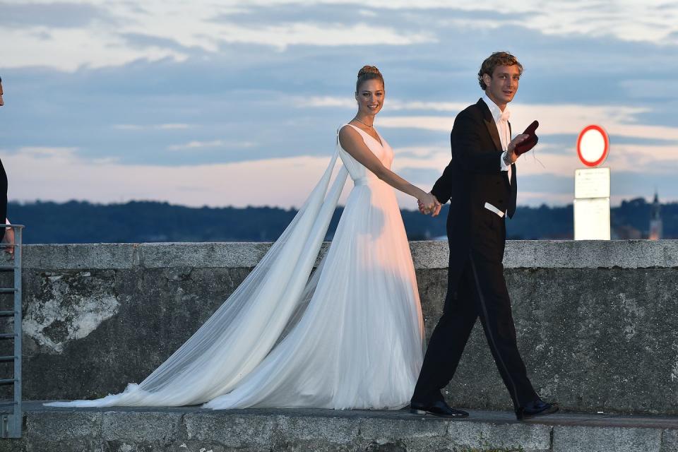 <p>Italian aristocrat, Beatrice Borromeo, wore five dresses for her wedding(s) to Princess Caroline of Monaco's son Pierre Casiraghi in 2015. Our favorite was her custom Giorgio Armani Privé gown, featuring a trailing cape and sweeping train, which she wore to their second reception on her family's private Italian island. </p>