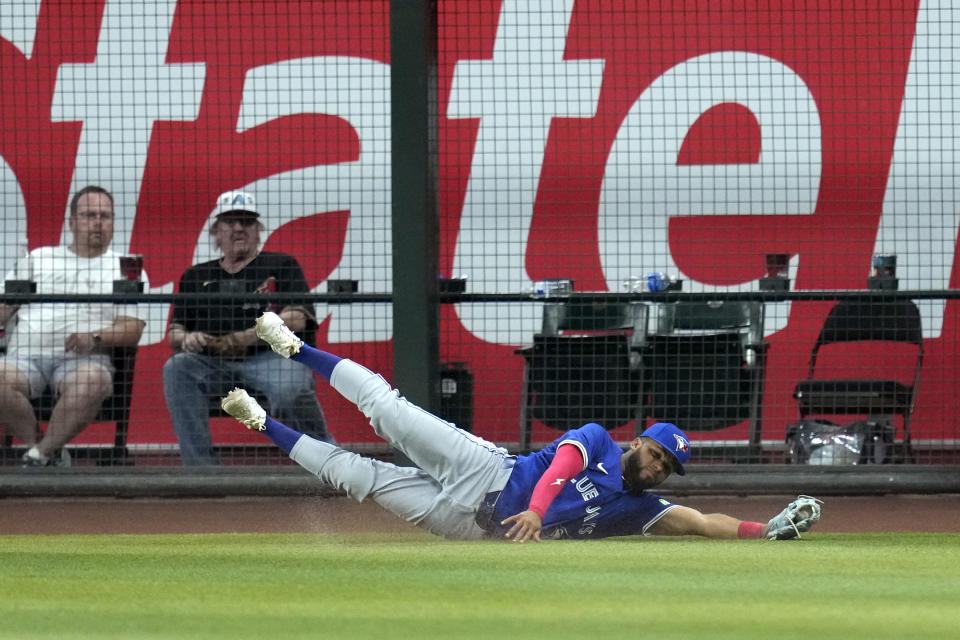 Toronto Blue Jays right fielder Steward Berroa makes a diving catch on a fly ball hit by Arizona Diamondbacks' Gabriel Moreno during the ninth inning of a baseball game, Sunday, July 14, 2024, in Phoenix. (AP Photo/Ross D. Franklin)