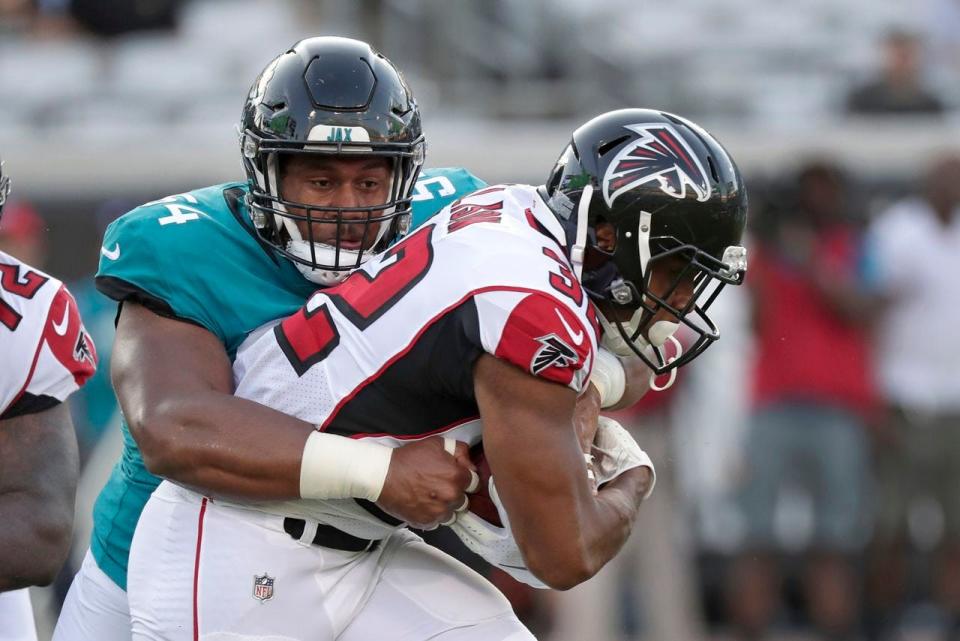 Jacksonville Jaguars defensive tackle Eli Ankou, left, stops Atlanta Falcons running back Qadree Ollison after a short gain during a 2019 preseason game in Jacksonville, Fla