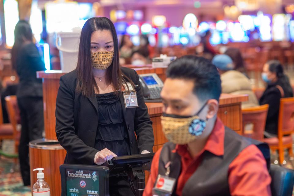 Supervisor Florence Luo, left, looks over the card area as Sopeak Chhim deals cards at Parx Casino in Bensalem on Thursday, January 20, 2022.