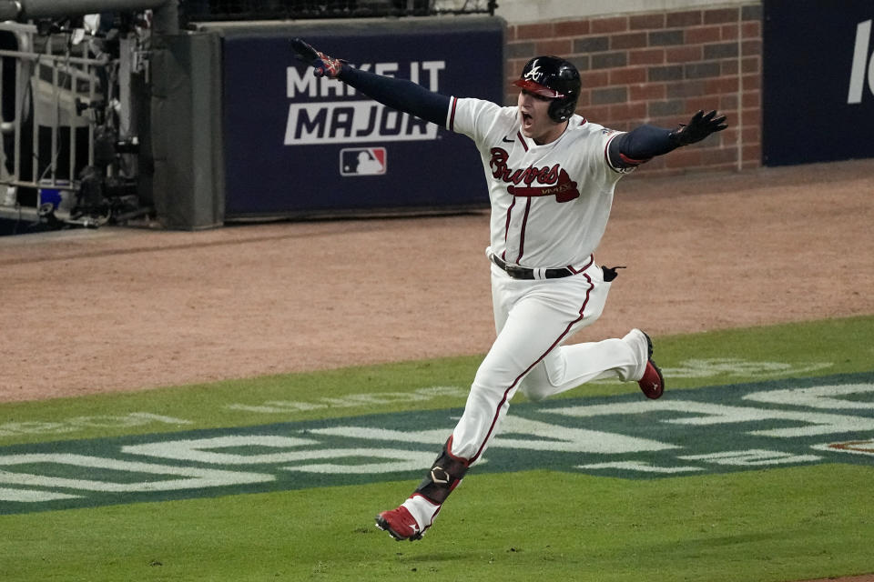 Atlanta Braves' Austin Riley celebrates after hitting the game winning RBI single to score Atlanta Braves' Ozzie Albies in the ninth inning in Game 1 of baseball's National League Championship Series against the Los Angeles Dodgers Saturday, Oct. 16, 2021, in Atlanta. The Braves defeated the Dodgers 3-2 to take game 1.(AP Photo/John Bazemore)