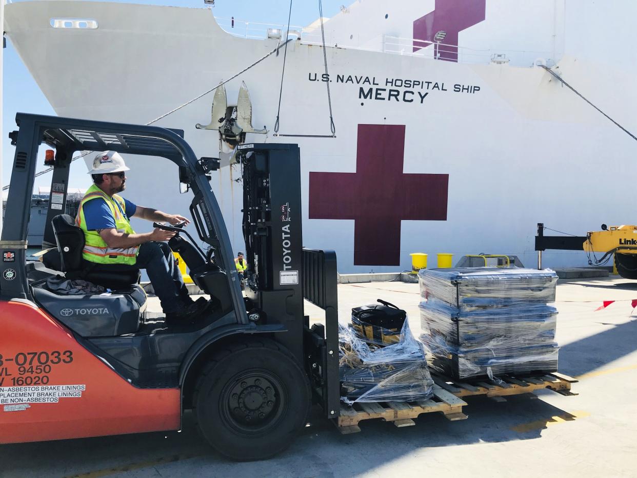 Steve King, a Naval Facilities Engineering Command Southwest forklift driver, prepares to deliver pallets during a supply load aboard the Military Sealift Command hospital ship USNS Mercy (T-AH 19) at Naval Base San Diego, adjacent to San Diego, Calif., Saturday, March 21, 2020.