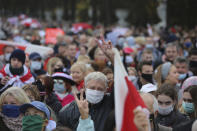 People, most of them pensioners, hold old Belarusian national flags march during an opposition rally to protest the official presidential election results in Minsk, Belarus, Monday, Oct. 26, 2020. Factory workers, students and business owners in Belarus have started a general strike, calling for authoritarian President Alexander Lukashenko to resign after more than two months of mass protests triggered by a disputed election. (AP Photo)