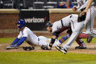 New York Mets' Pete Alonso looks up after scoring the game-winning run against Arizona Diamondbacks catcher Carson Kelly, center, during the 10th inning of a baseball game Friday, May 7, 2021, in New York. (AP Photo/John Minchillo)