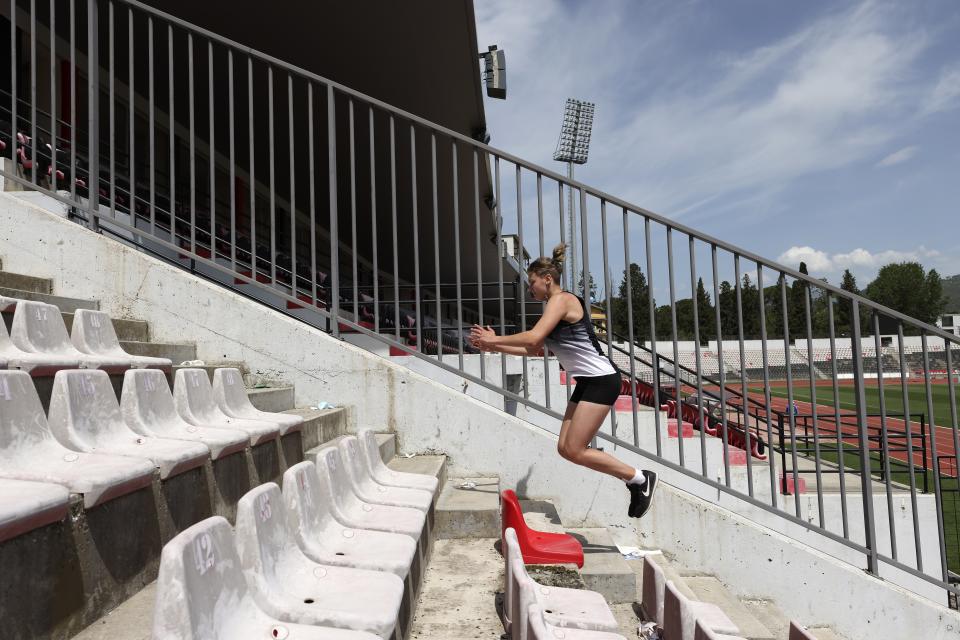 Ukrainian athlete Hanna Tkachova, 19, practices during a training session at Elbasan Arena stadium in Elbasan, about 45 kilometers (30 miles) south of Tirana, Albania, Monday, May 9, 2022. After fleeing from a war zone, a group of young Ukrainian track and field athletes have made their way to safety in Albania. Their minds are still between the two countries. (AP Photo/Franc Zhurda)