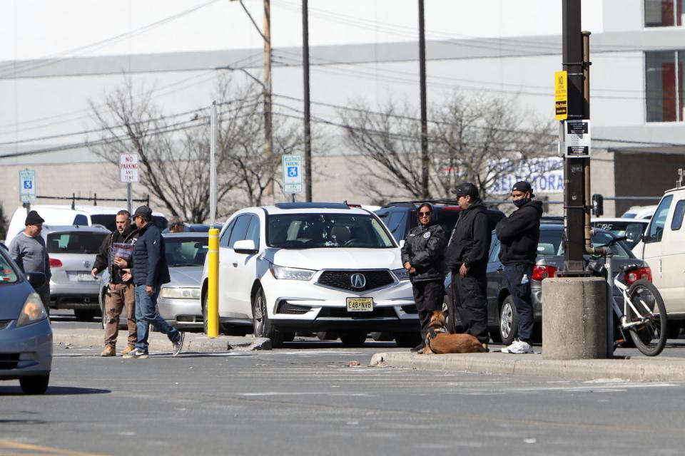 Security guards with a K-9 stand outside The Home Depot in New Rochelle April 22, 2024.