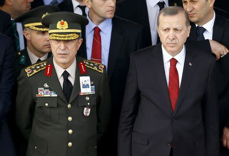 Turkish President Tayyip Erdogan (R) and Chief of Staff General Hulusi Akar attend a funeral ceremony for Army officer Seckin Cil in Ankara, Turkey, February 18, 2016. REUTERS/Umit Bektas/File Photo